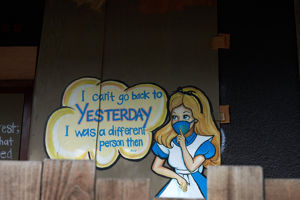 Wall mural reading: I can't go back to yesterday, I was a different person then